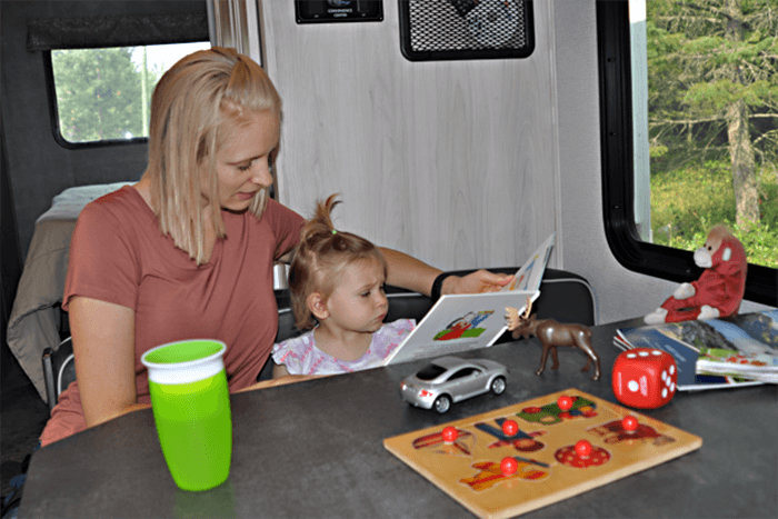 Mother and child in RV reading a child's book