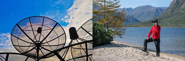 Satellite dish and man talking on sat phone in remote area