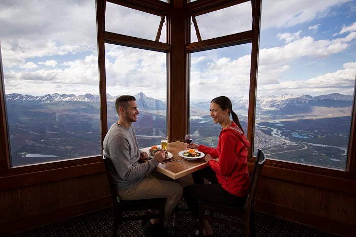 Couple eating and admiring the view from the Summit Cafe