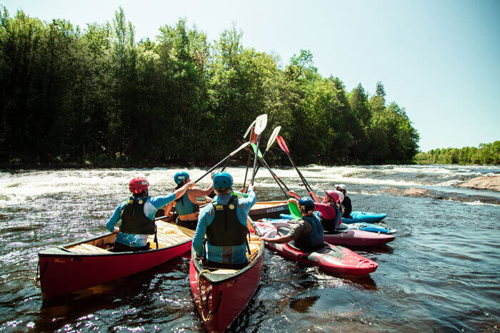 Rafters touching oars in a raft