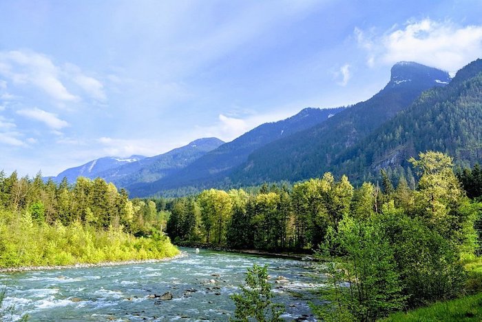 River running by trees and mountains in fall