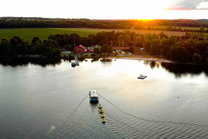 Sunrise over the water with buildings on shoreline of river