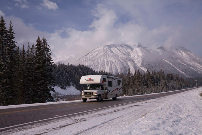 RV on winter road in the Canadian Rockies