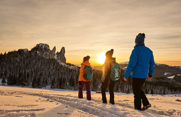 hikers-setting-out-at-dawn-with-sun-rising-ahead-of-them.jpg