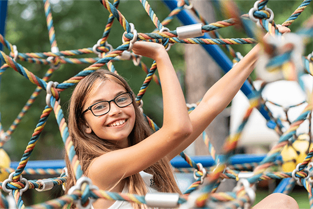 Young girl on climbing frame