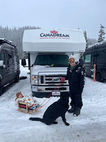 Man and Balck dog in front of CanaDream RV