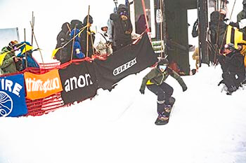 Snowboarder out of the starting gate at competition
