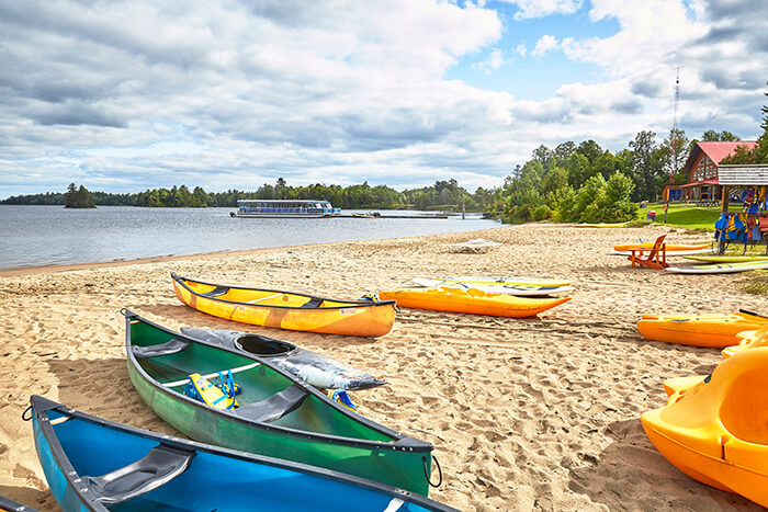 Colourful canoes on a sandy beach