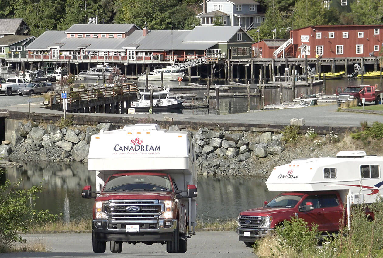 Two CanaDream truck and camper RVs leaving Telegraph Cove BC
