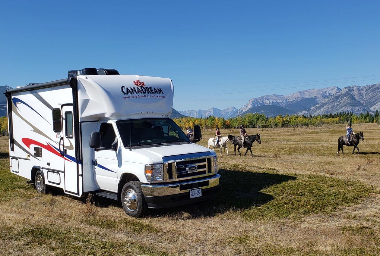 CanaDrean Super van Camper with horses passing by