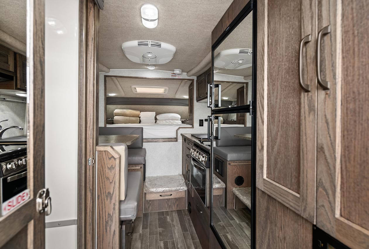 Dinette, kitchen and queen overcab bed in CanaDream truck and camper
