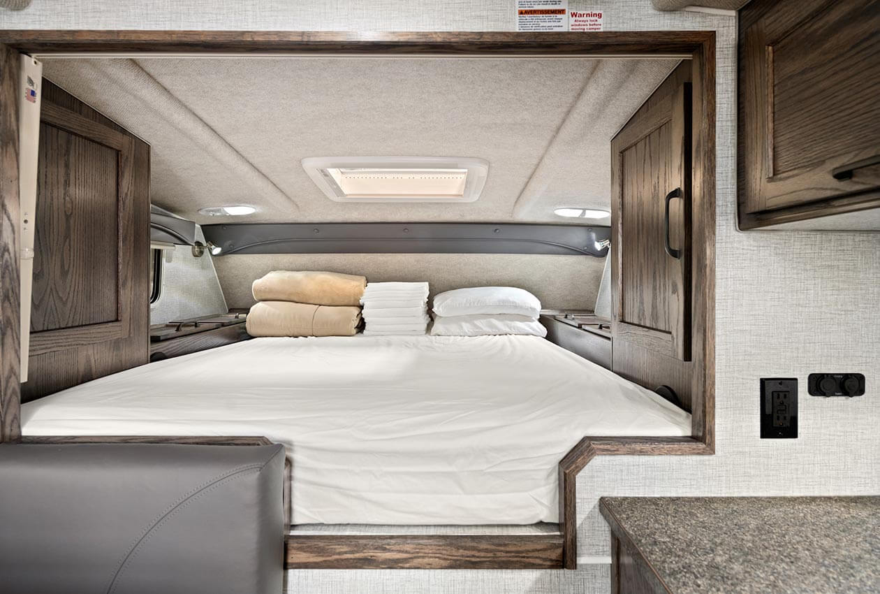 Queen bed in overcab in CanaDream Truck and Camper TCA