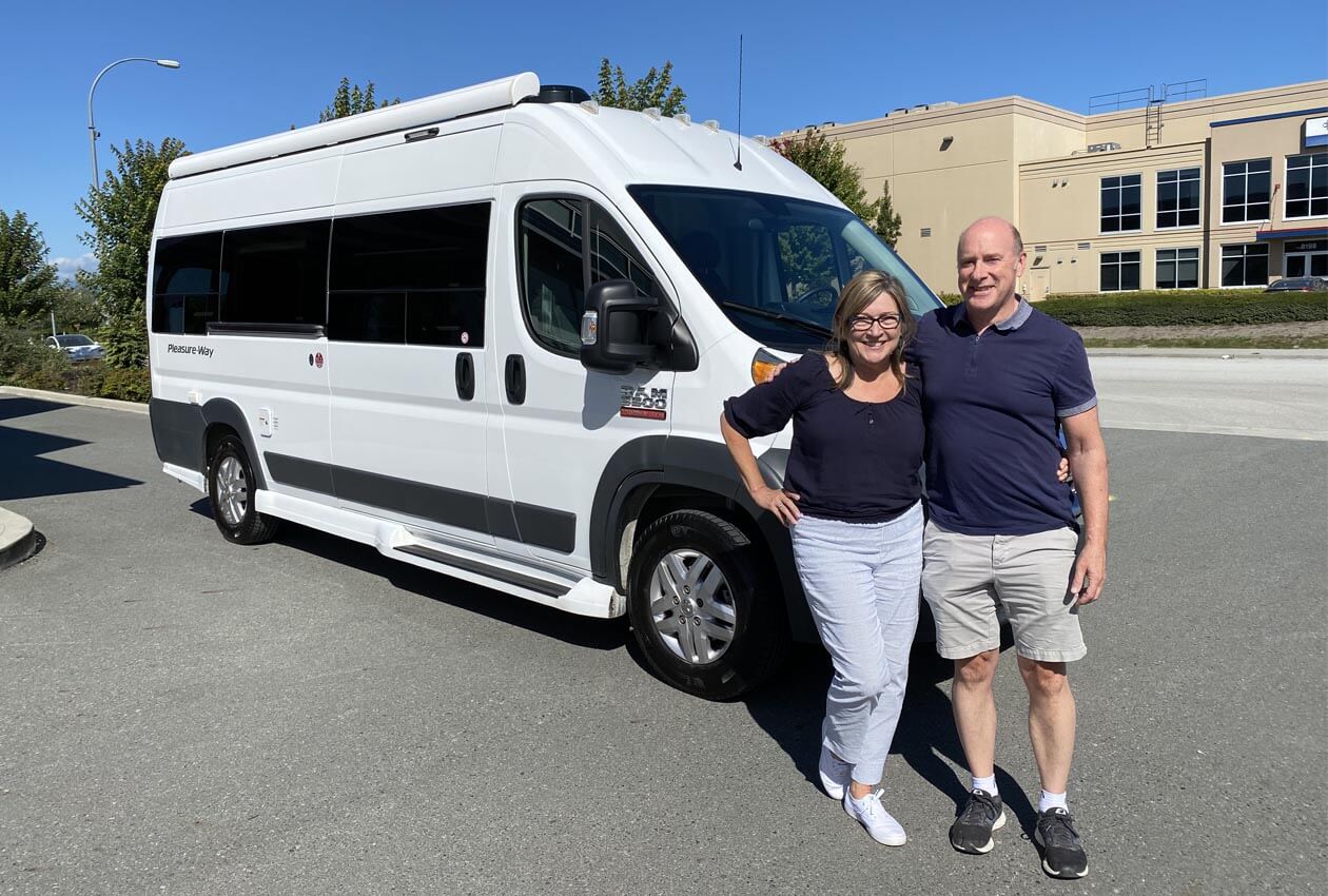 Happy-couple-with-their-new-PleasureWay-campervan Description