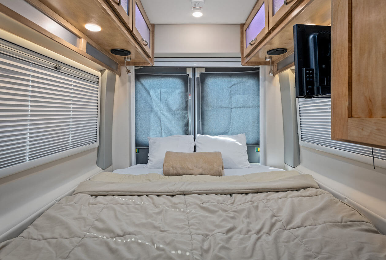 Rear sleeping area CanaDream Deluxe Van Camper